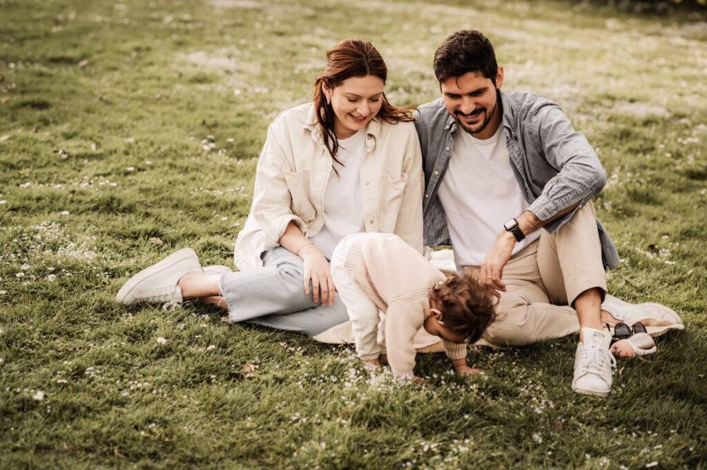 Familie mit kleiner Tochter beim Picknick auf einer Wiese